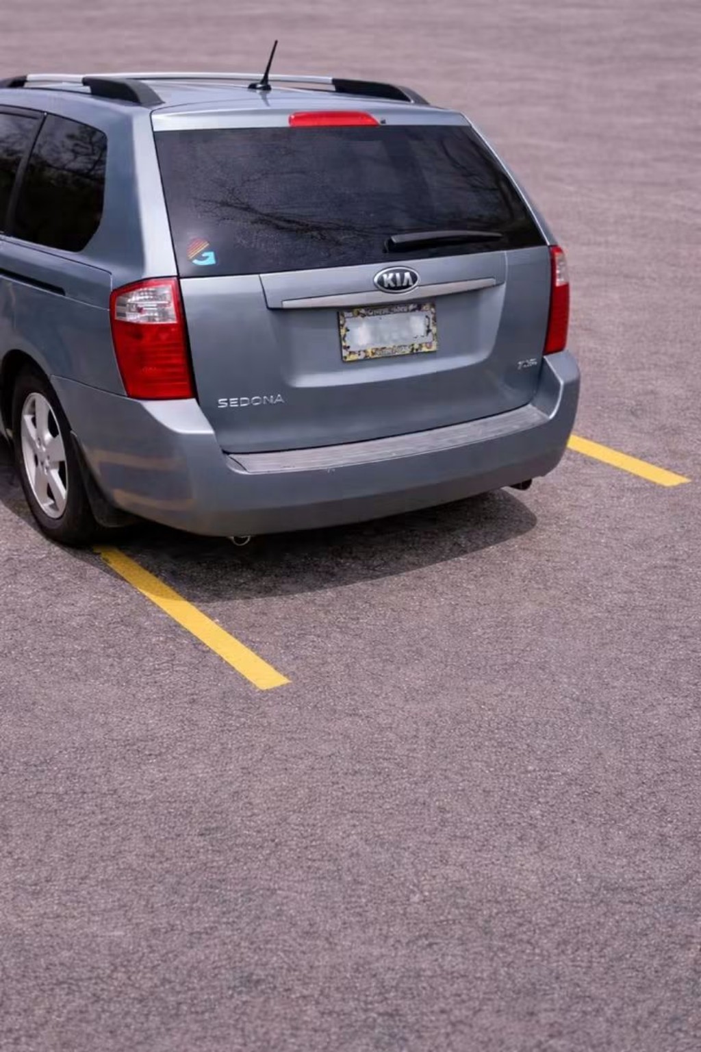 A humorous illustration of a gray van parked imperfectly at the end of a row